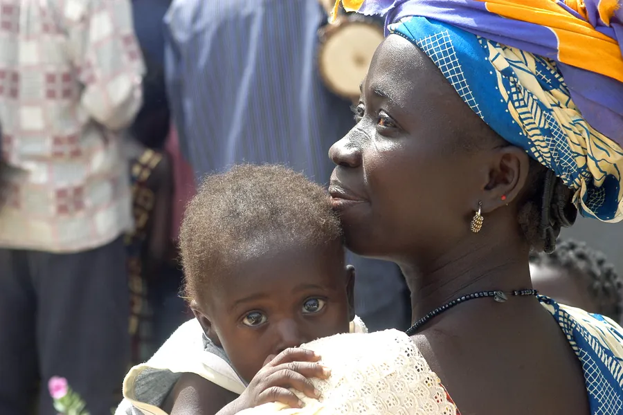 African mother with baby looing over shoulder